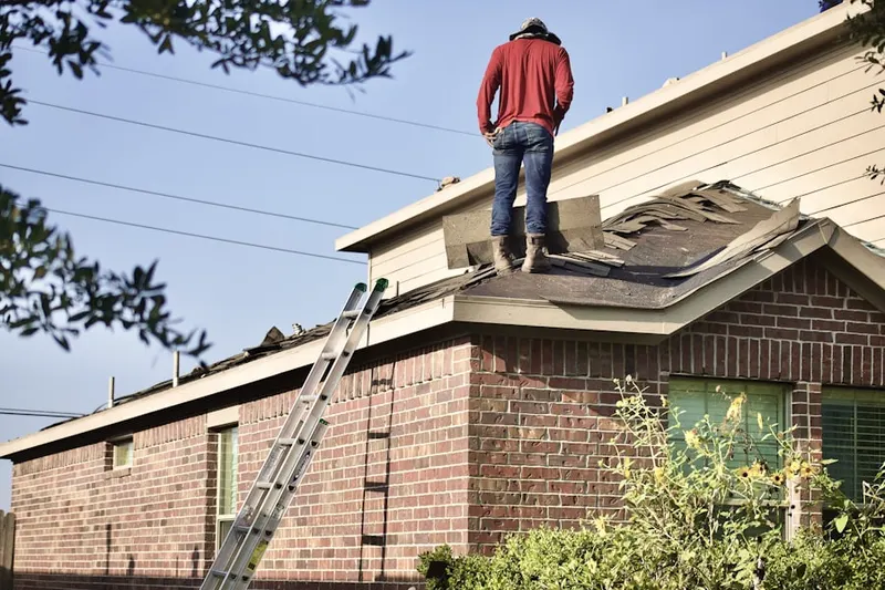 Professional roofer working on a residential roof in North Potomac